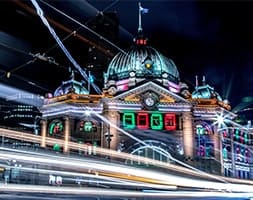 Beautiful Building At Night With Car Lights Passing