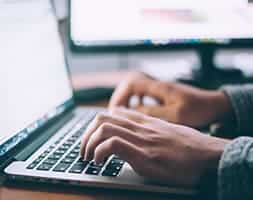 Close Up View of A Person's Hand Typing On A Laptop