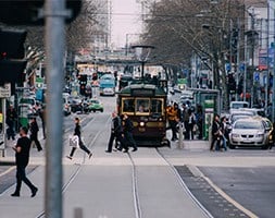 People Crossing On A Busy Road