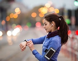 Female Runner Setting Timer on Watch