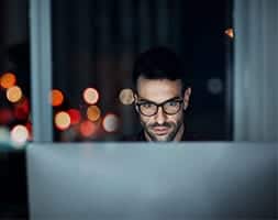 Man Working At Night on His Computer