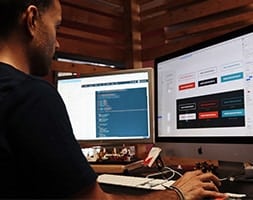Man in Black Shirt Working with 2 Computer Screens