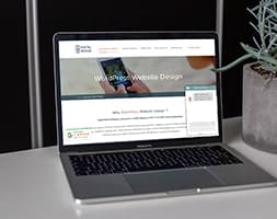Laptop on An Office Desk with A Table Plant