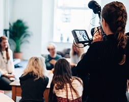 Group of ladies in meeting with videographer recording