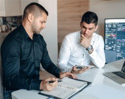 Two Men Discussing Data