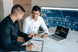 Men Discussing The Data and Taking Down Notes