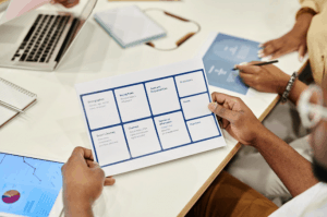 Man Holding A Sheet of Paper in A Meeting