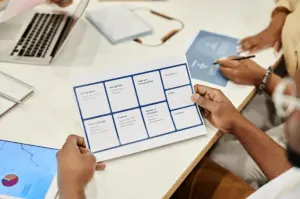 Man Holding A Sheet of Paper in A Meeting