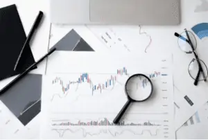 Table with Pens, Magnifying Glass, Chart and Eyeglass