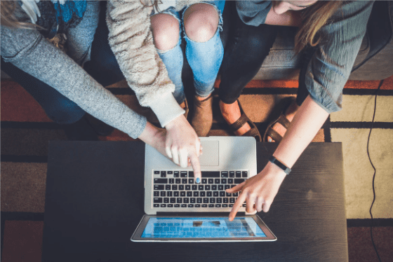 Three Persons Pointing At the Laptop Screen