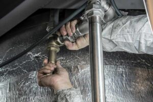 A Person Fixing Plumbing Fixture
