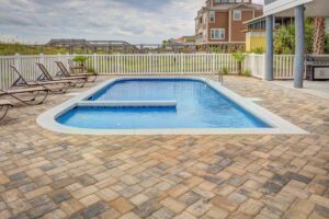 Swimming pool surrounded with white fence