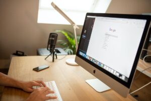 A Person Browsing on Google Using an iMac