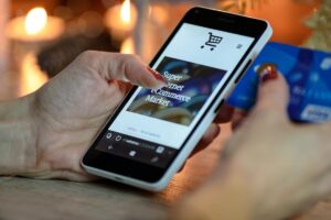 A person with a credit card browsing online shops
