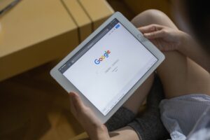A person holding a white tablet.