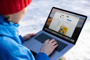 Man Browsing on Facebook using A Laptop