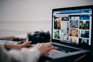Person Browsing Images Online Using A MacBook