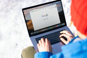 Person Browsing on Google with A Laptop