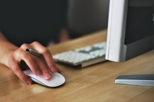 Person Clicking On A Wireless Mouse
