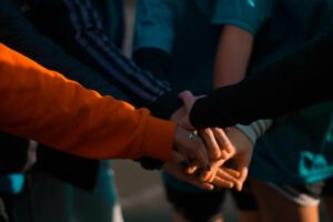 Group Of People Huddling Up
