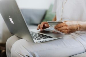 Woman On A Laptop Holding A Credit Card