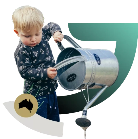 Small boy pouring water out of a watering can